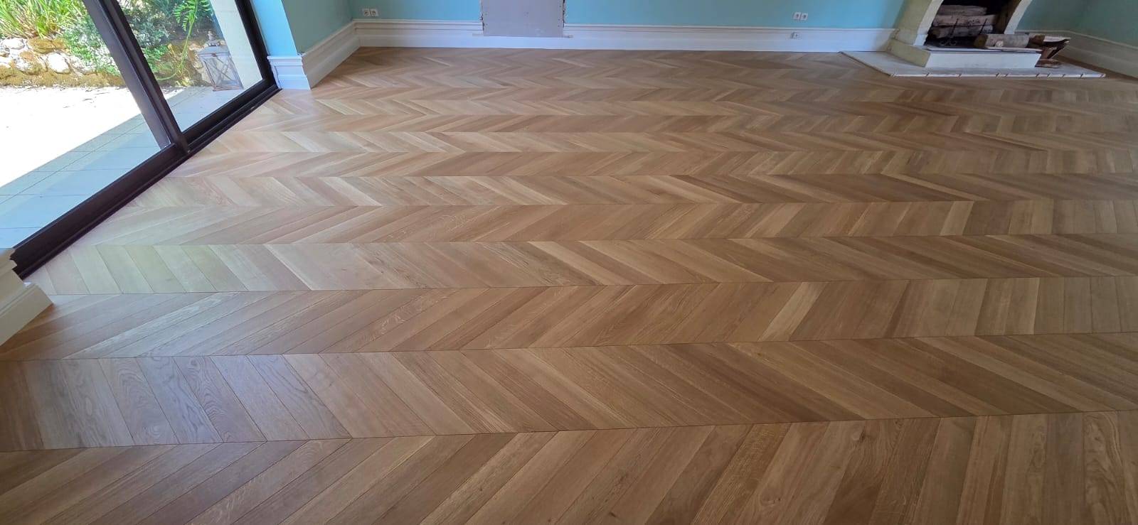 Installation d’un parquet point de Hongrie dans un salon moderne à Bordeaux rive gauche