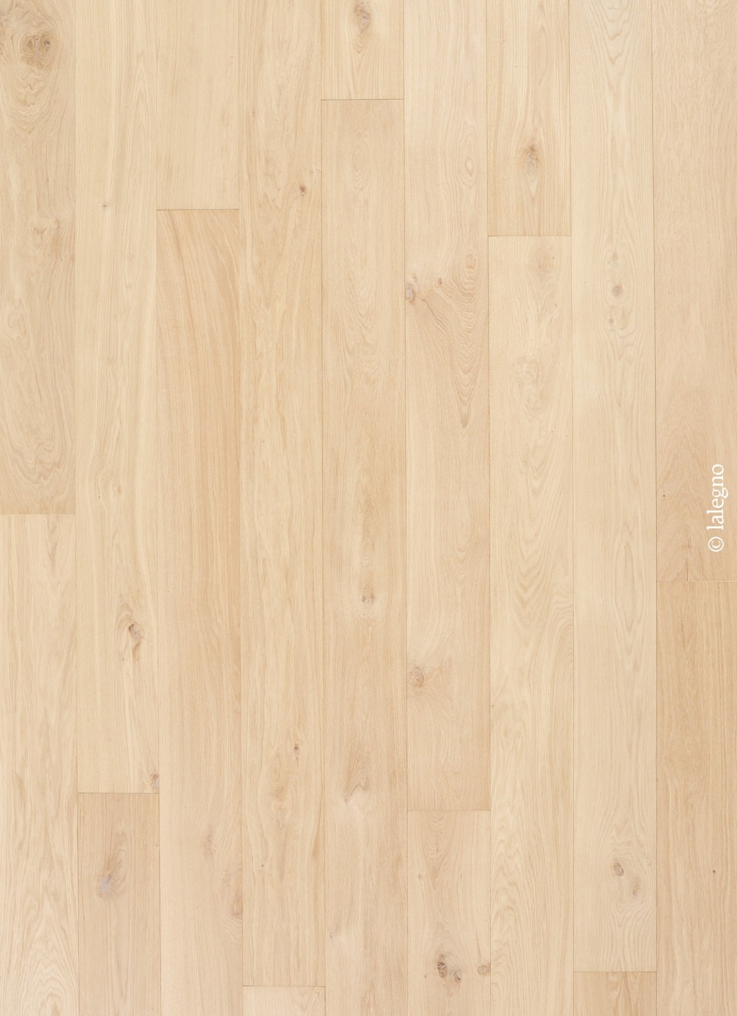 Sol en parquet chêne clair naturel. Lames longues à pose décalée, mettant en valeur le grain et les petits nœuds. © lalegno