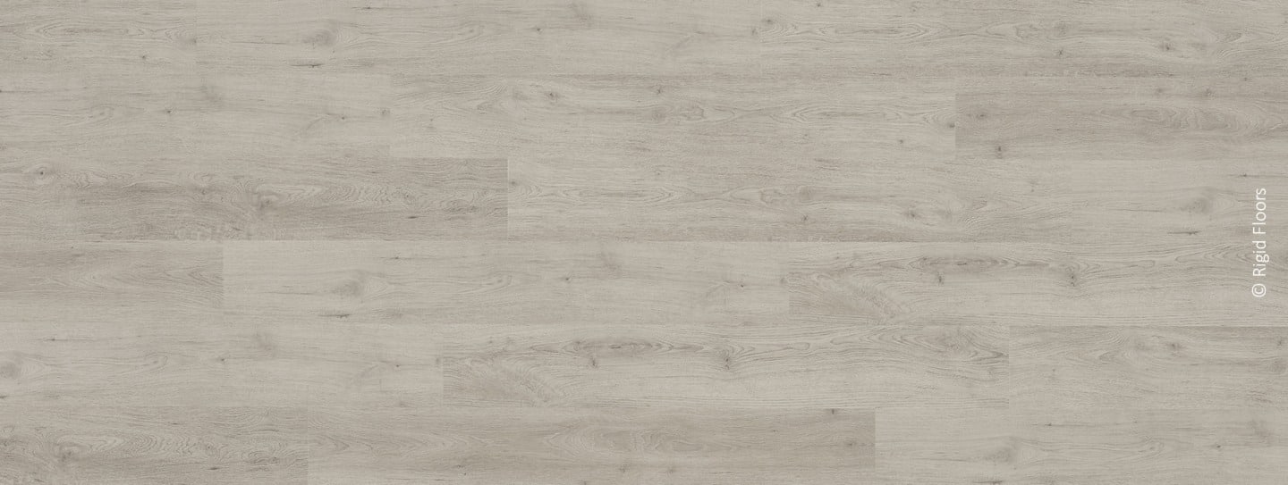 Sol rigide en lames larges, imitation bois chêne gris clair ou blanchi, avec grain visible. (Rigid Floors).